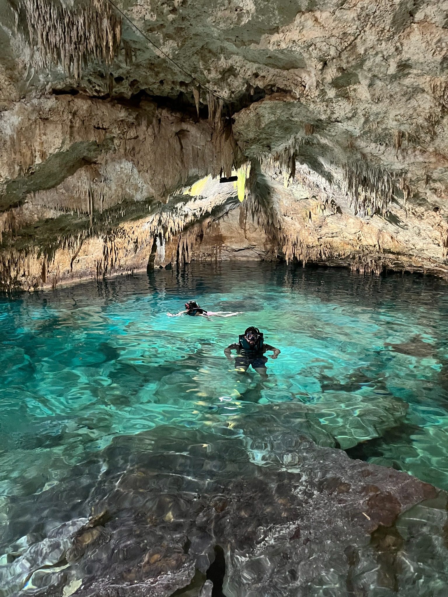 Clear turquoise water inside a cave cenote in Yucatan