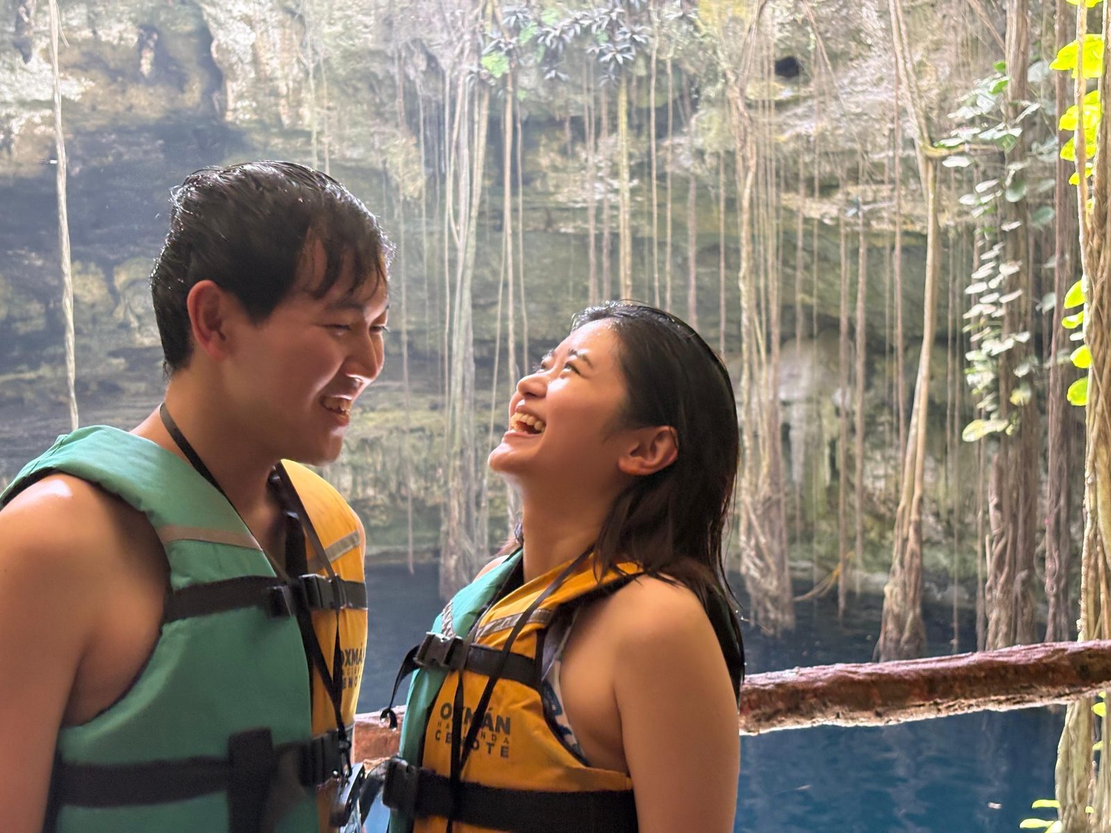 Travelers smiling together at Cenote Oxman after visiting Chichen Itza
