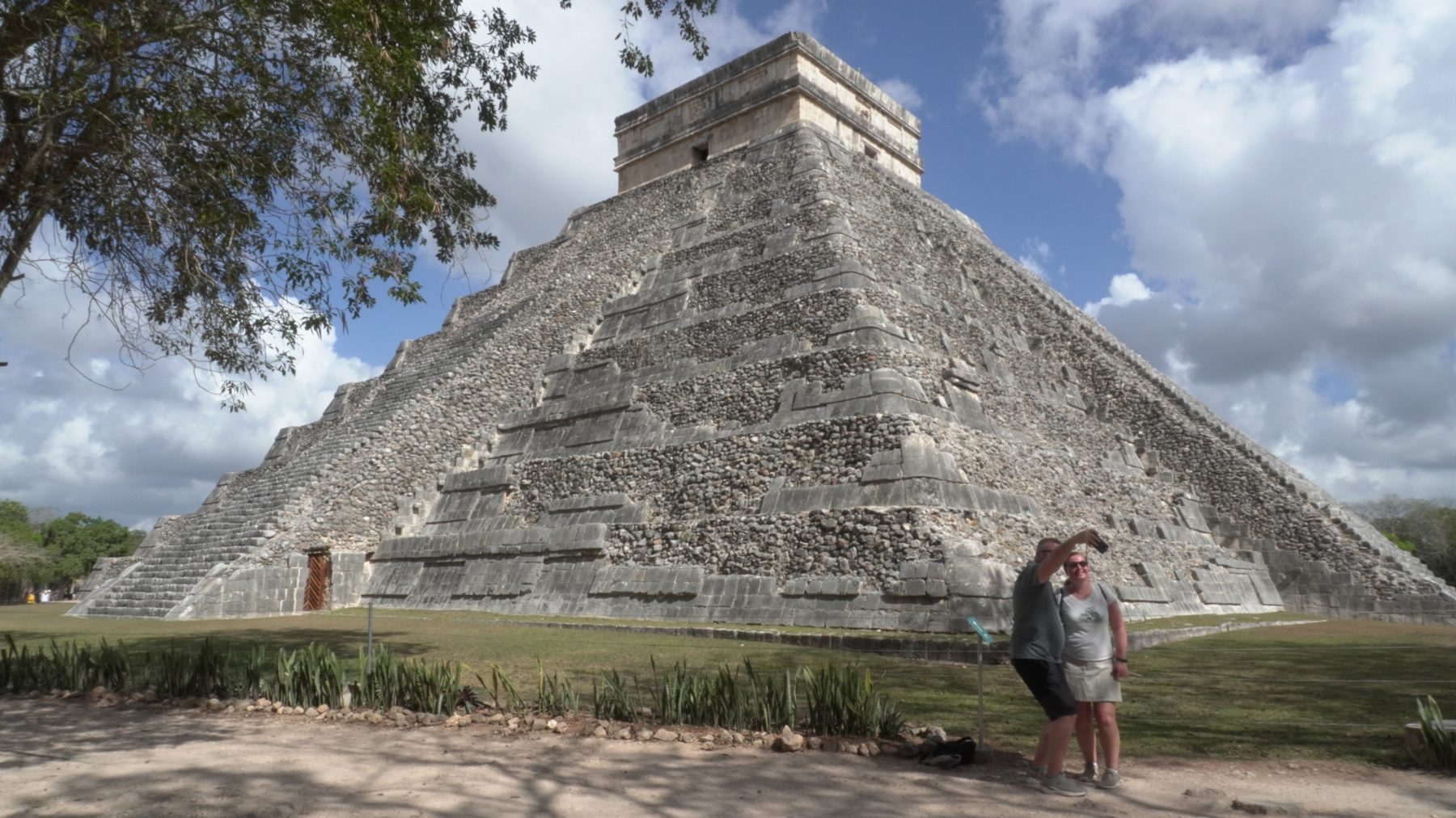 El Castillo pyramid at Chichen Itza with travelers during a private tour