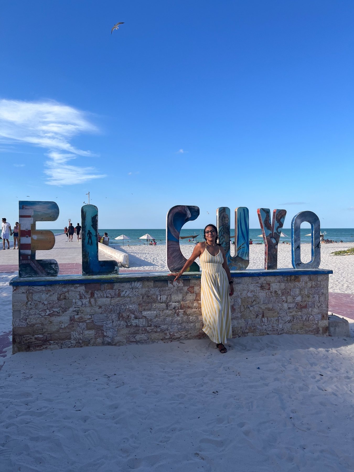 El Cuyo colorful beach sign in Yucatán with blue sky and ocean behind