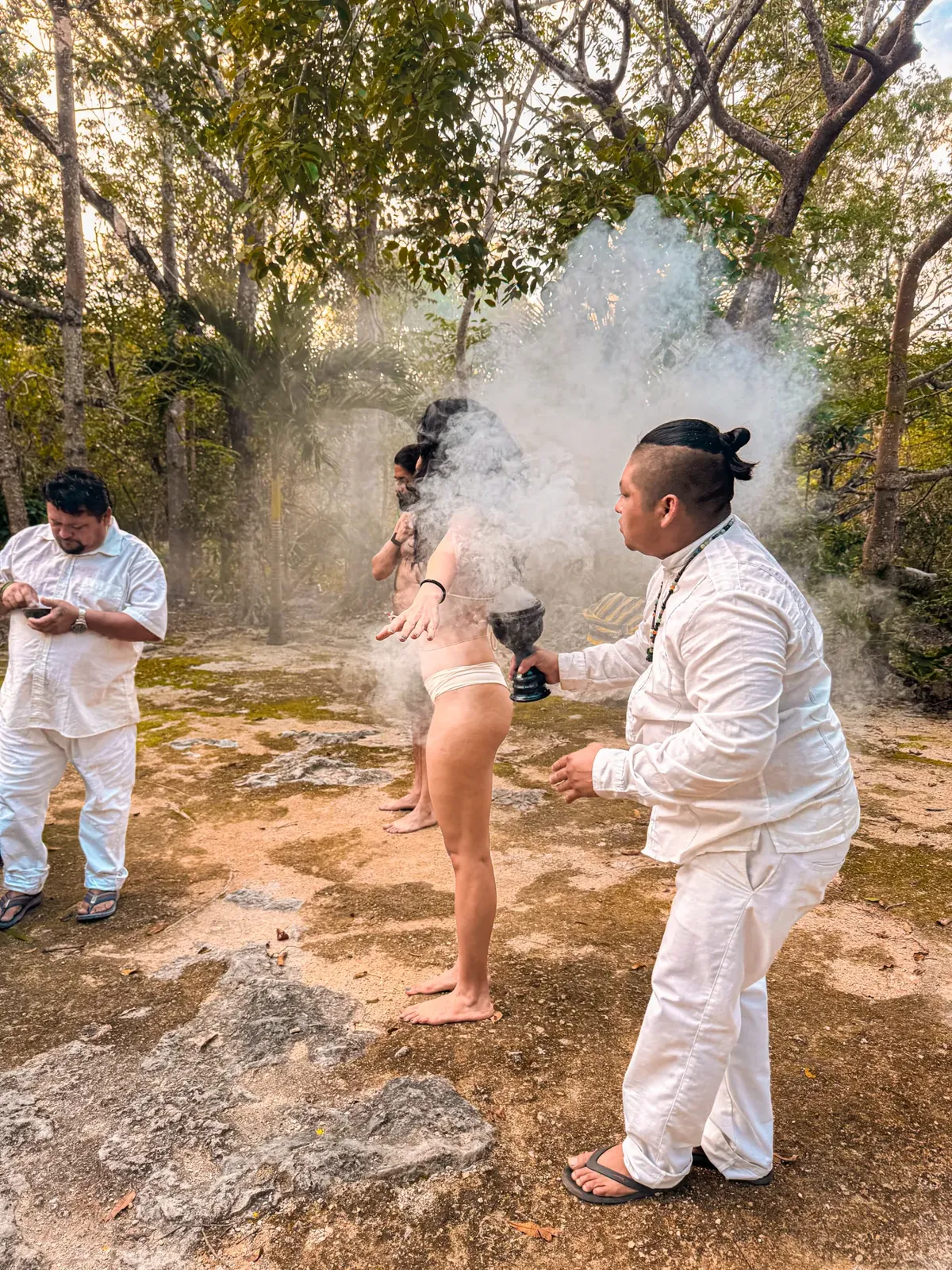 A moment of the temazcal experience with smoke and local facilitators