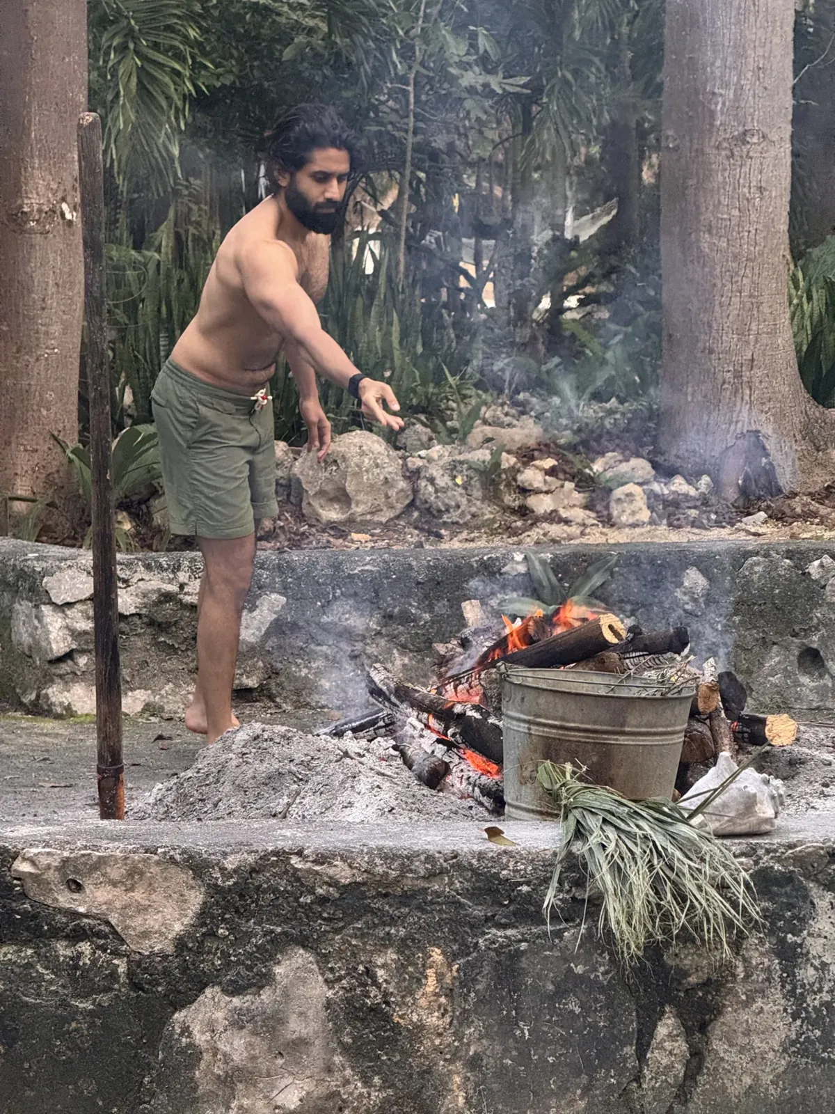 Firewood and hot stones being prepared for a temazcal ceremony