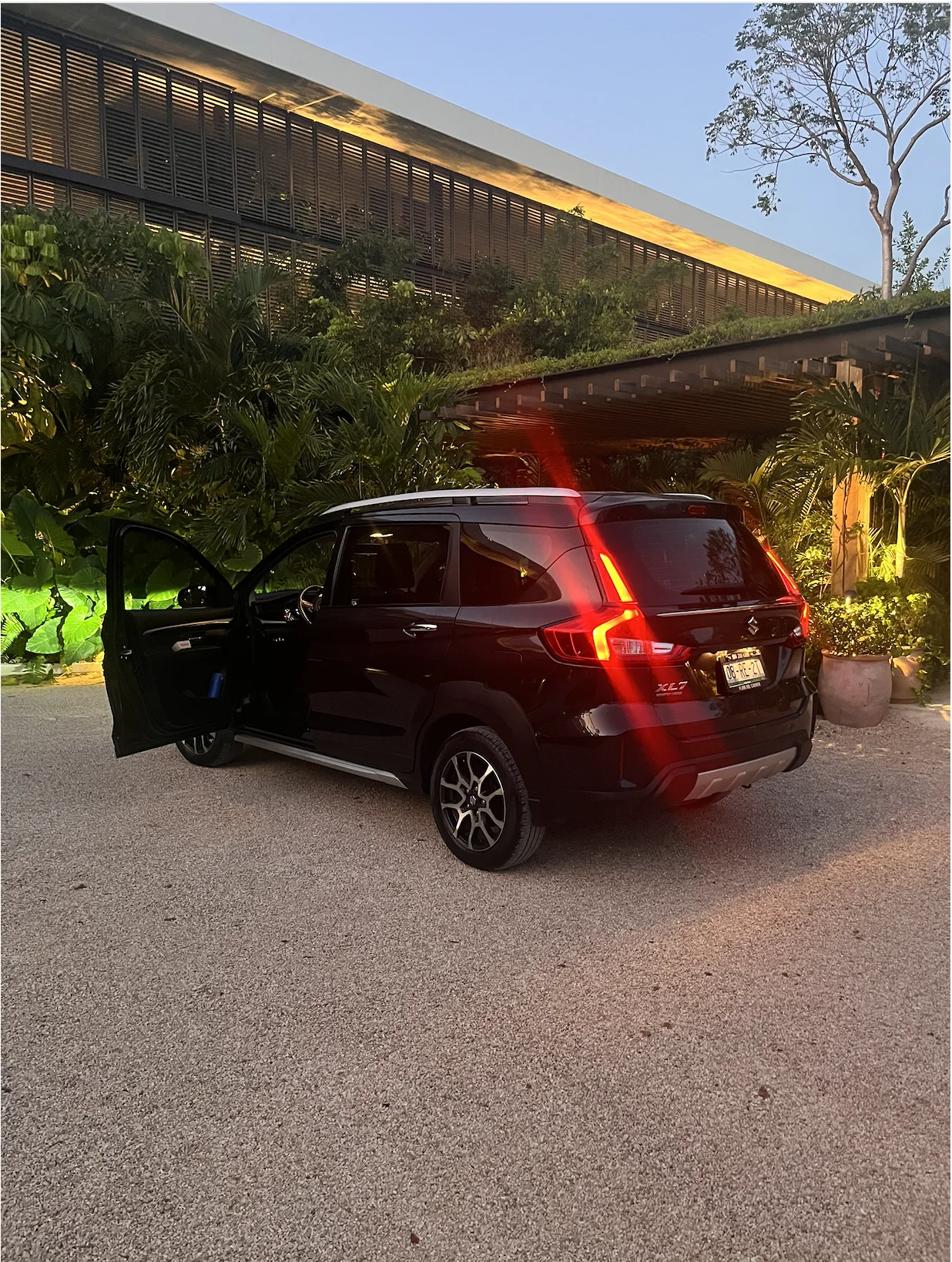 Rear view of the Suzuki at a hotel entrance
